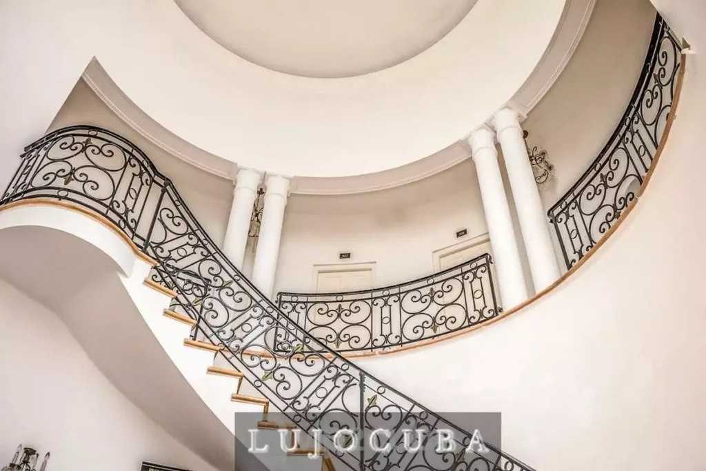 Curved staircase and iron balustrade inside Mansion El Duque