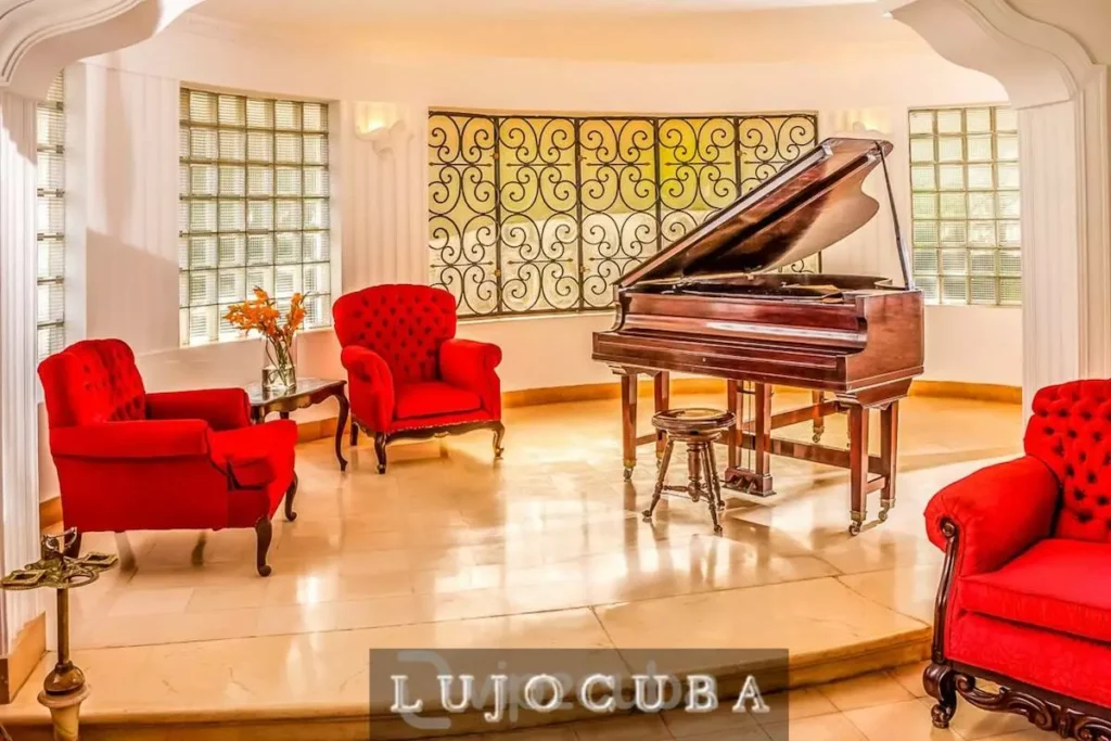 Piano lounge with red armchairs at Mansion El Duque