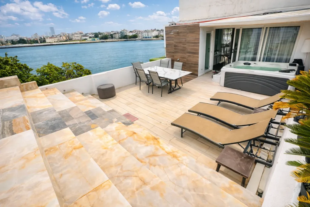 Marble sun terrace overlooking the water at Penthouse Rio Mar