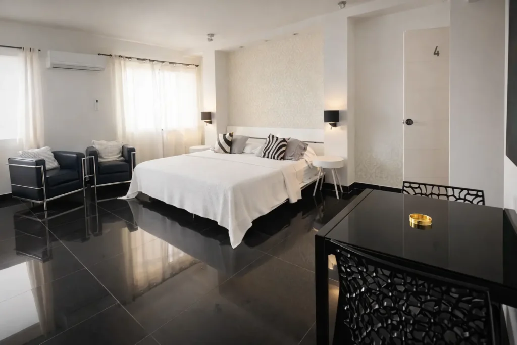 Bright bedroom with seating inside Penthouse Rio Mar