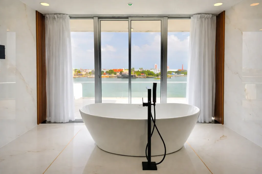 Freestanding tub facing the water at Penthouse Rio Mar