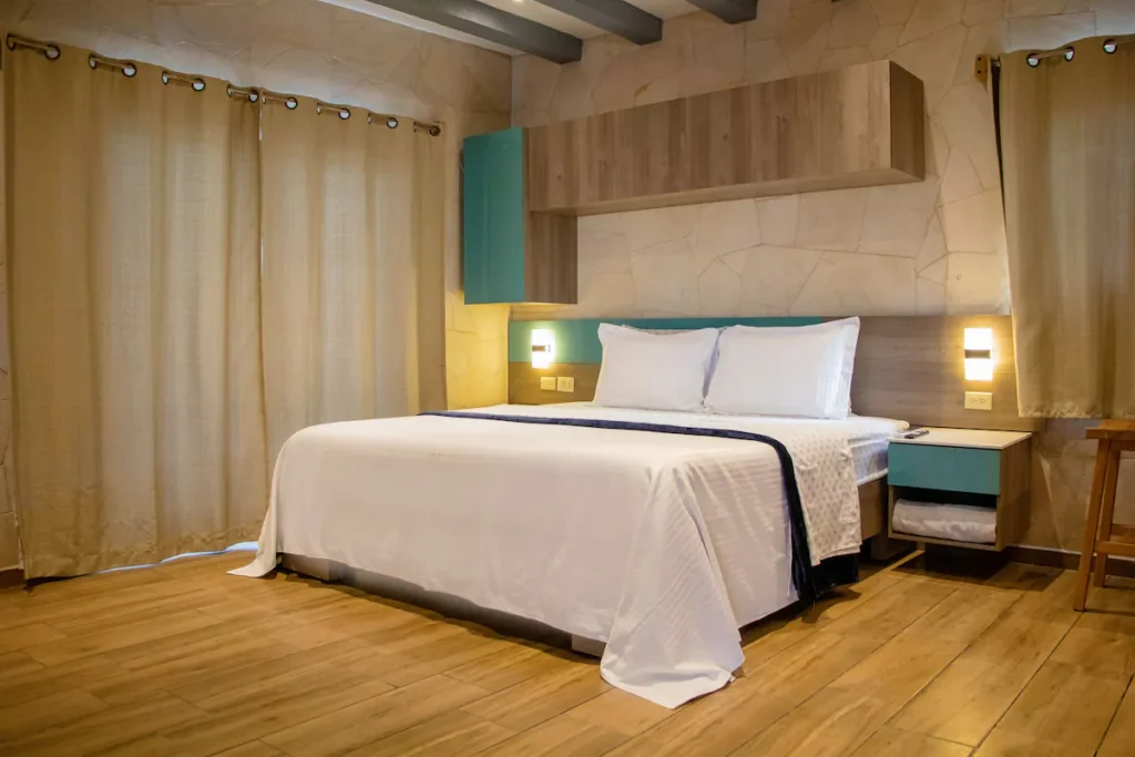 Warm timber bedroom with turquoise details at The Loft