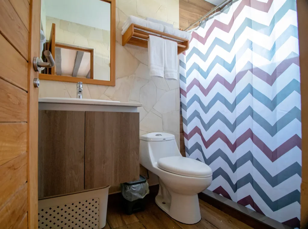 Bathroom with patterned shower and warm timber finishes