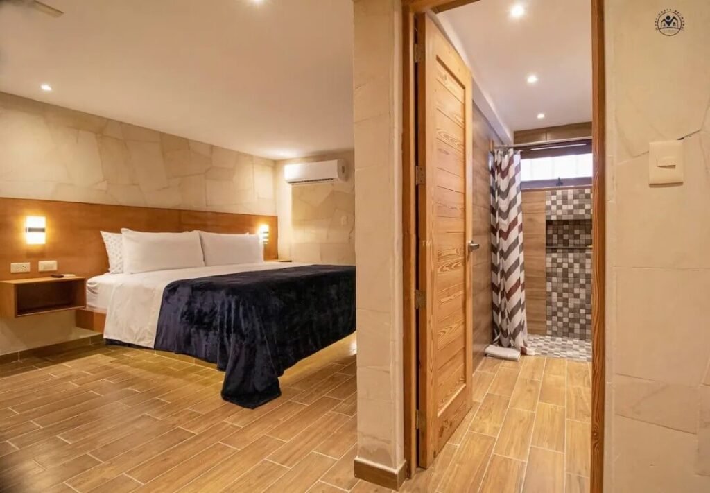 Warm timber bedroom with dark blue bedding