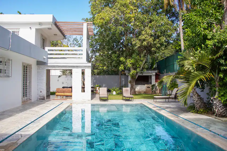 Villa Aurora white mid-century exterior and private pool in Siboney, Havana
