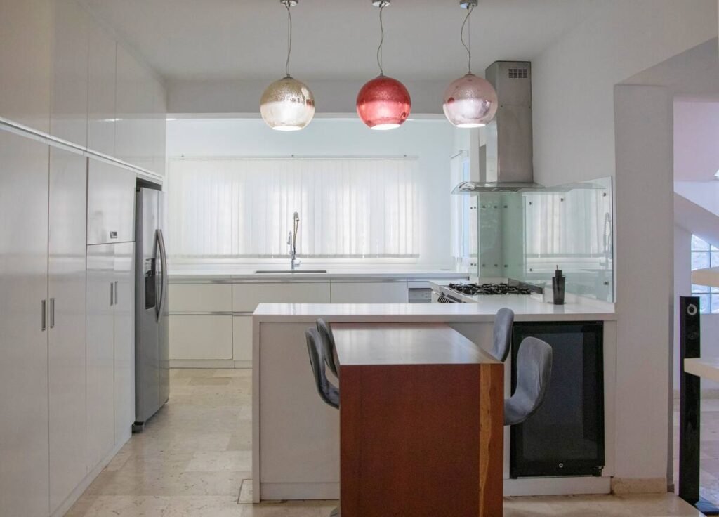 White kitchen with dining island at Villa Aurora