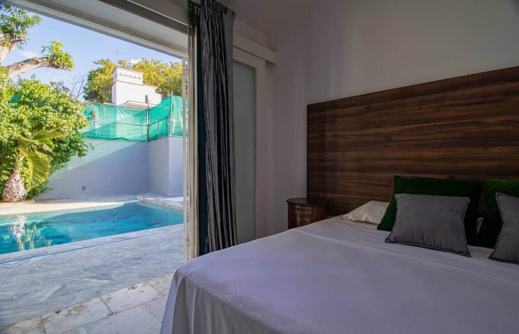 Garden-facing bedroom at Villa Aurora in Havana