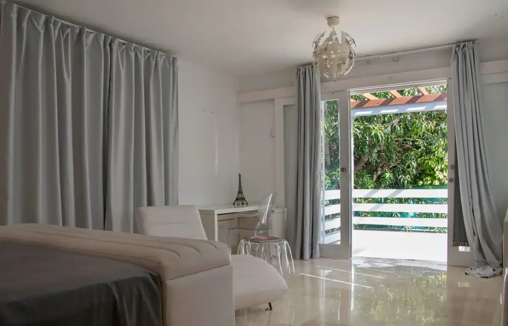 Bedroom opening to a private balcony at Villa Aurora
