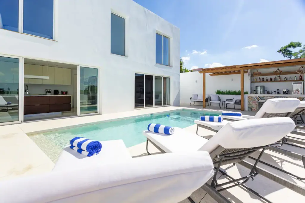 White sun loungers beside the Villa Bella pool