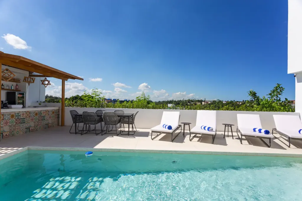 Open sky and green outlook beyond the Villa Bella pool
