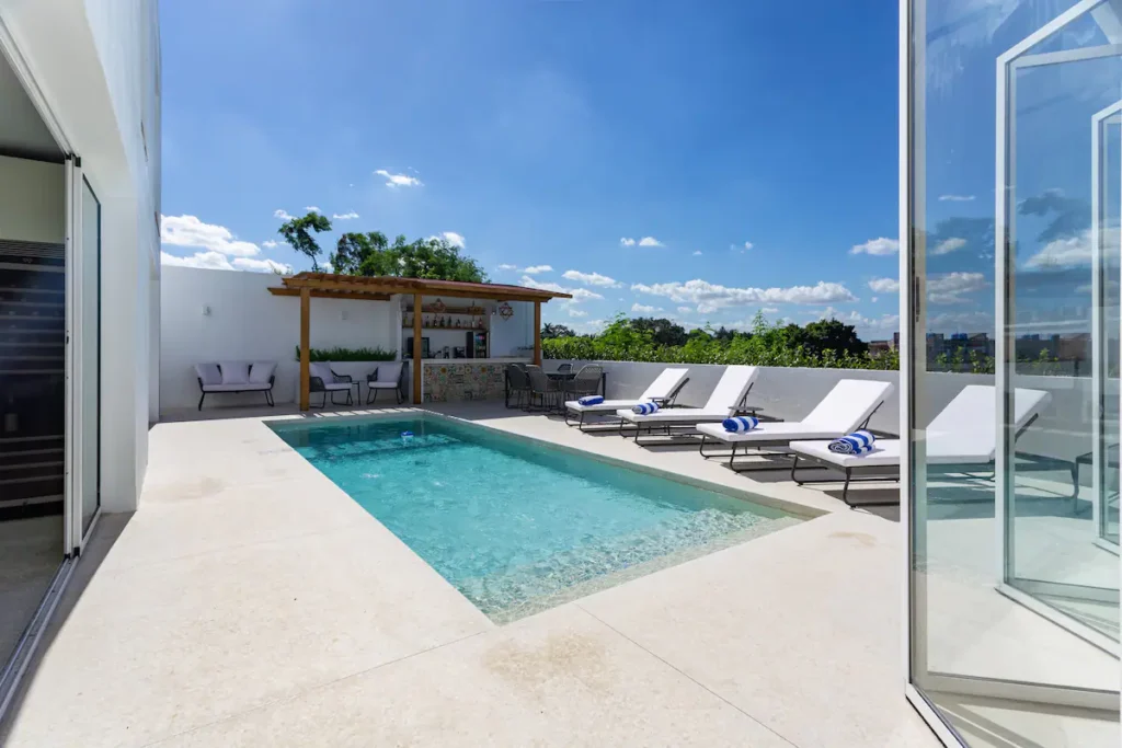 Villa Bella pool viewed through open glass doors