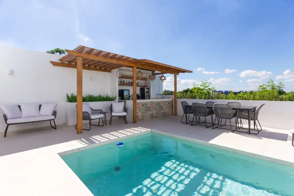 Timber pergola with outdoor dining beside the pool