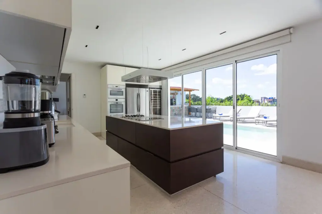 Modern kitchen island overlooking the Villa Bella pool