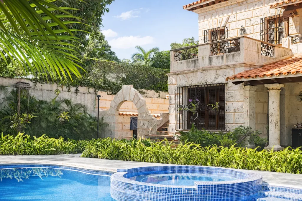 Stone exterior of Villa Castle beside its pool