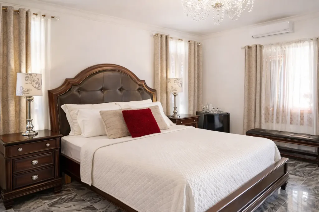 Spacious king bedroom with dark wood furniture at Villa Castle