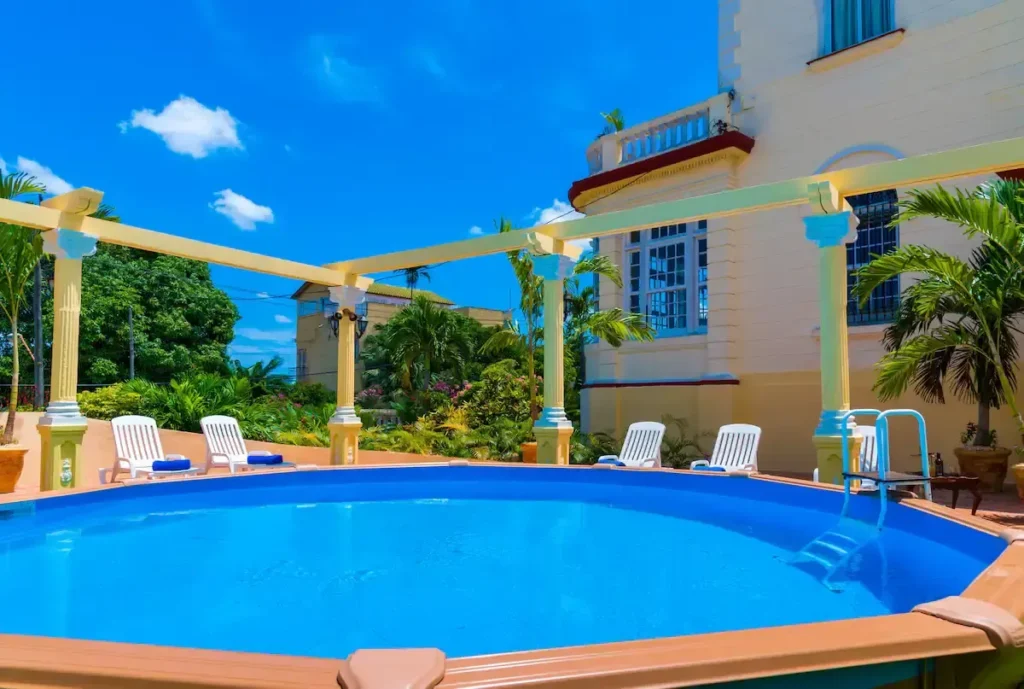 Blue swimming pool beside the Villa Condesa exterior