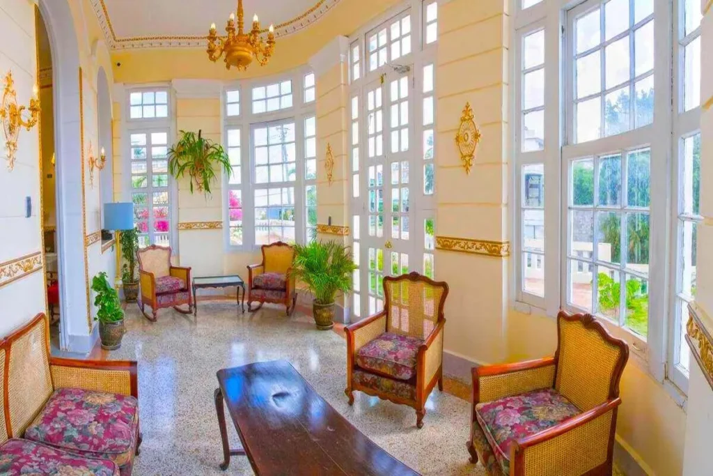 Bright glazed sitting room at Villa Condesa in Havana