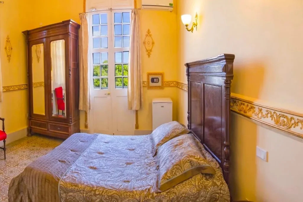 Double bedroom with tall windows at Villa Condesa