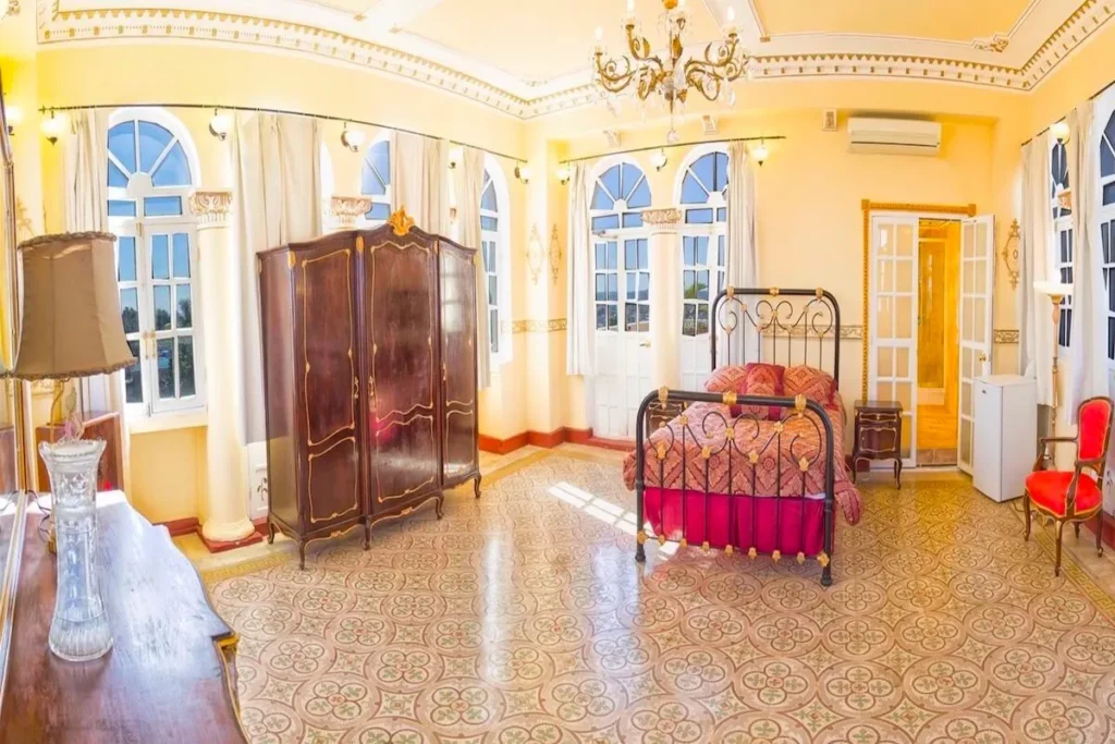 Large double bedroom with arched windows at Villa Condesa
