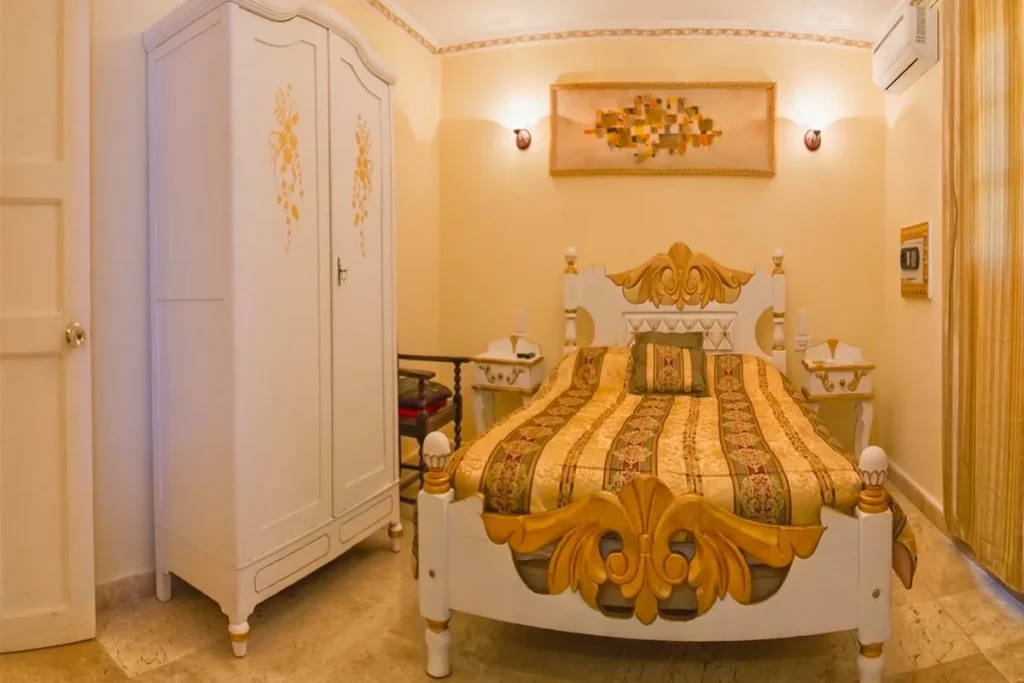 Decorative double bed and fitted storage at Villa Condesa
