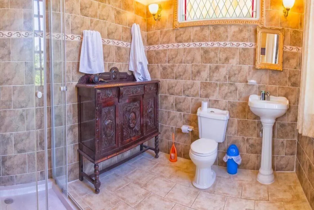 Tiled bathroom with antique vanity at Villa Condesa