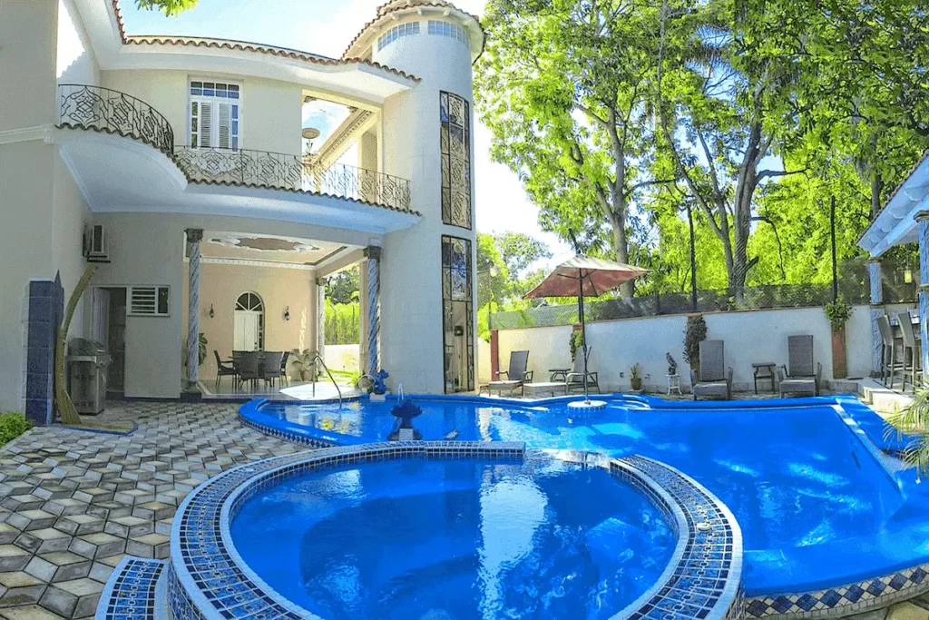 Circular jacuzzi in front of Villa Costa's white façade