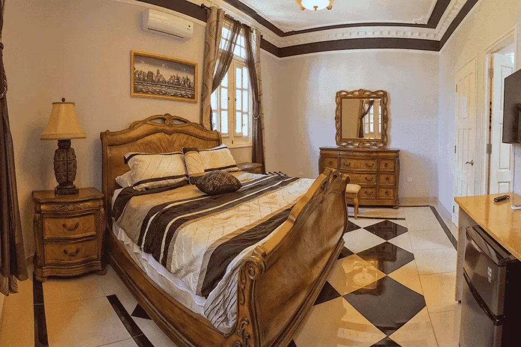 Traditional bedroom with carved double bed at Villa Costa