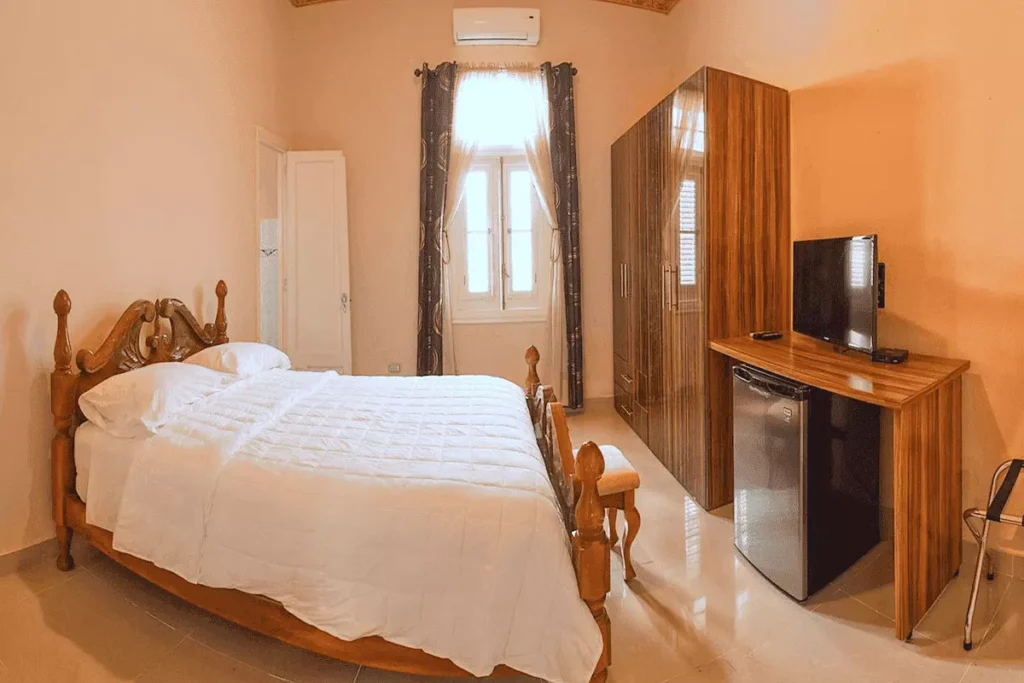 Warm-toned double bedroom inside Villa Costa