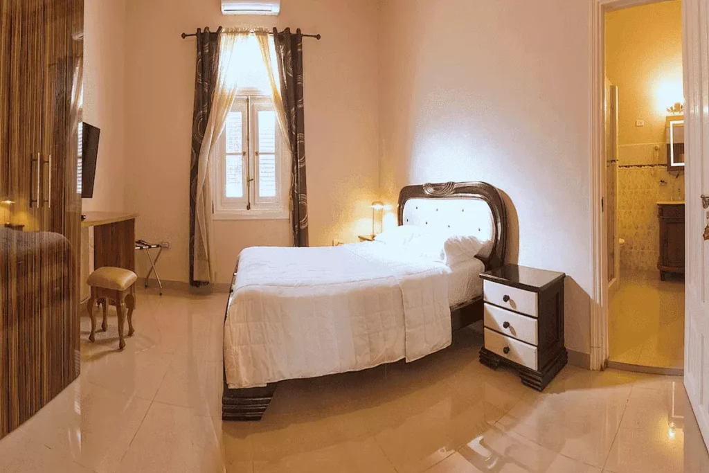 Spacious bedroom with double bed and television at Villa Costa