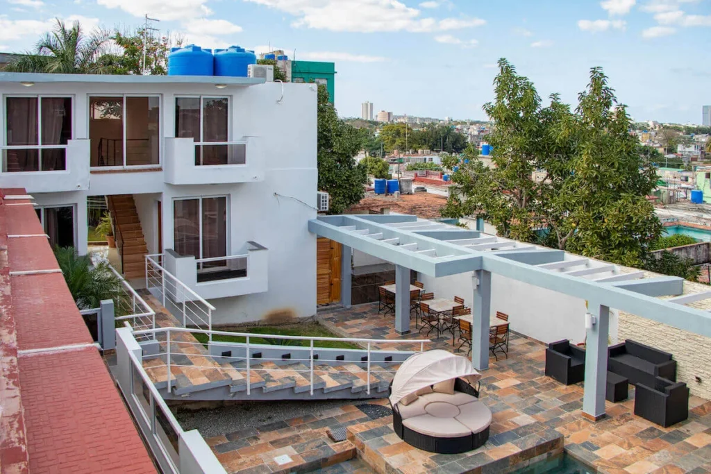Two-level white façade overlooking the Villa Don courtyard