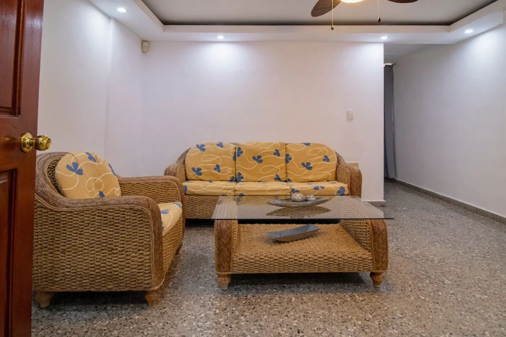 Indoor sitting room with gold armchairs at Villa Don