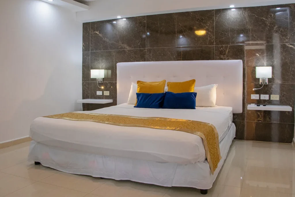 King bedroom with dark stone wall at Villa Don