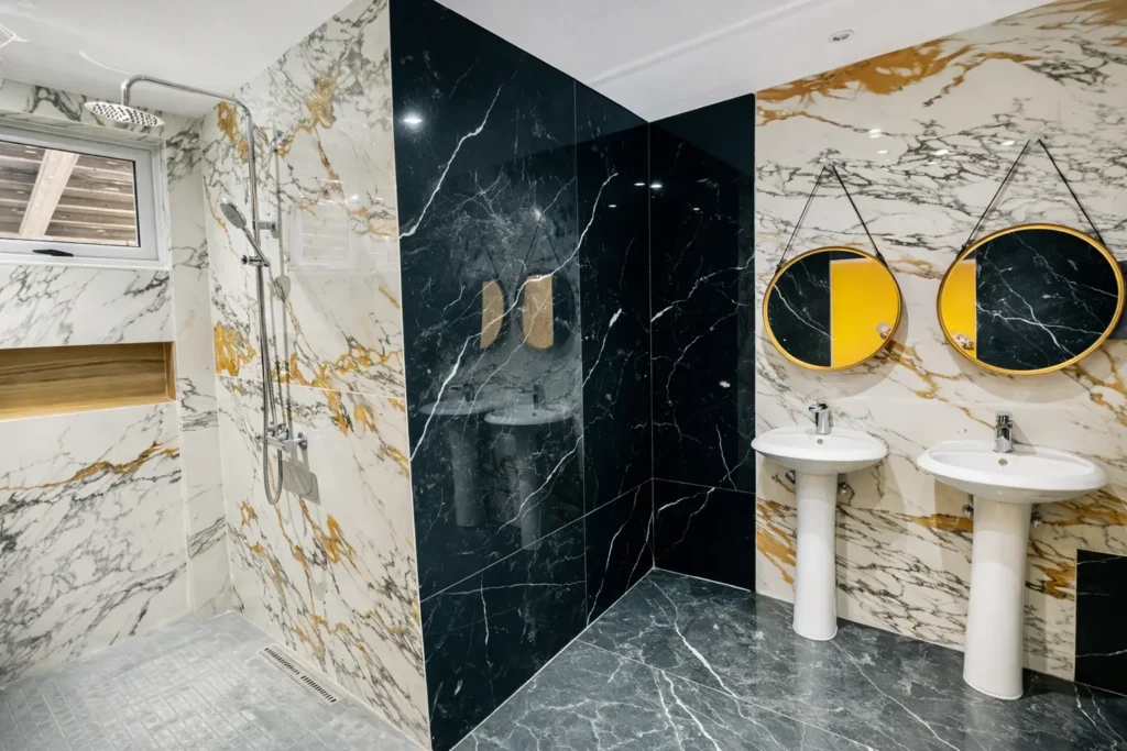Black marble bathroom with twin basins at Villa Dream