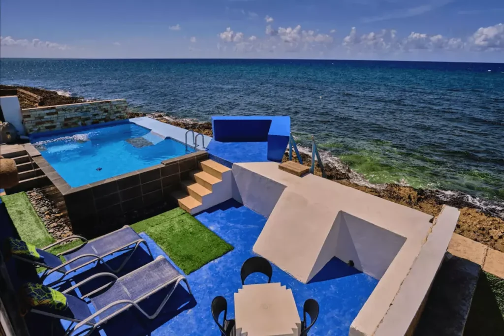 Elevated view of the Villa Isis pool beside the sea