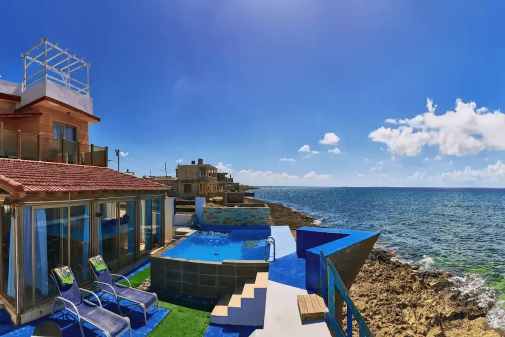 Villa Isis exterior, pool terraces and panoramic sea view