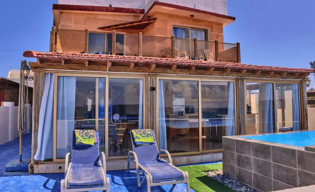 Villa Isis glass façade, loungers and sea-view pool