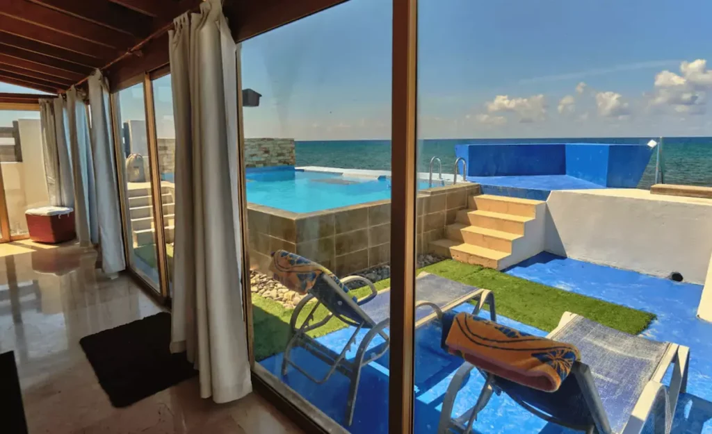 Sea-view pool seen through the Villa Isis glass doors