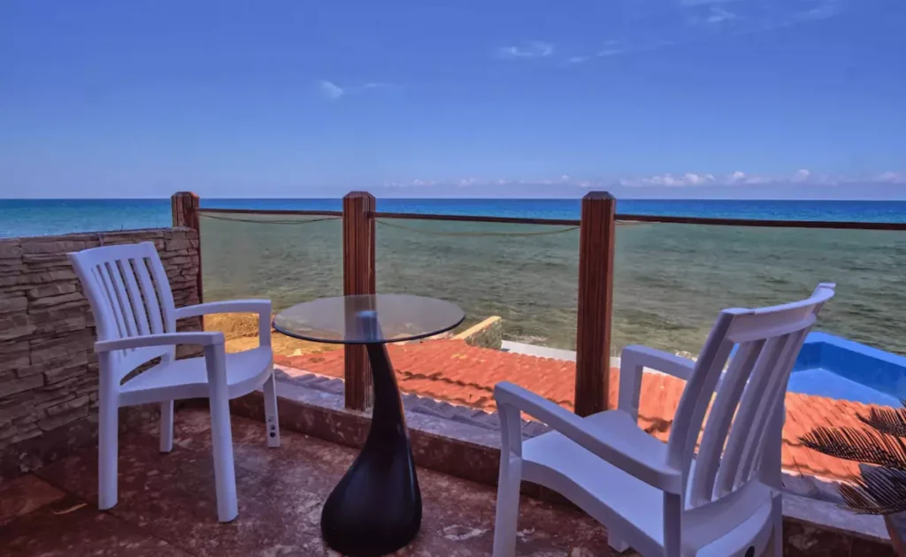 Private terrace with chairs overlooking the sea at Villa Isis
