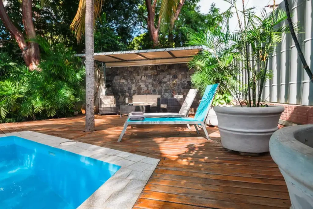 Poolside daybed and timber deck at Villa Las Cañas