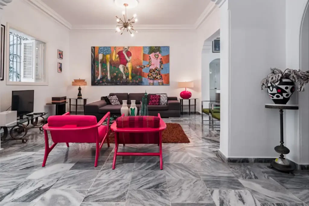 Formal living room with vivid red chairs at Villa Las Cañas