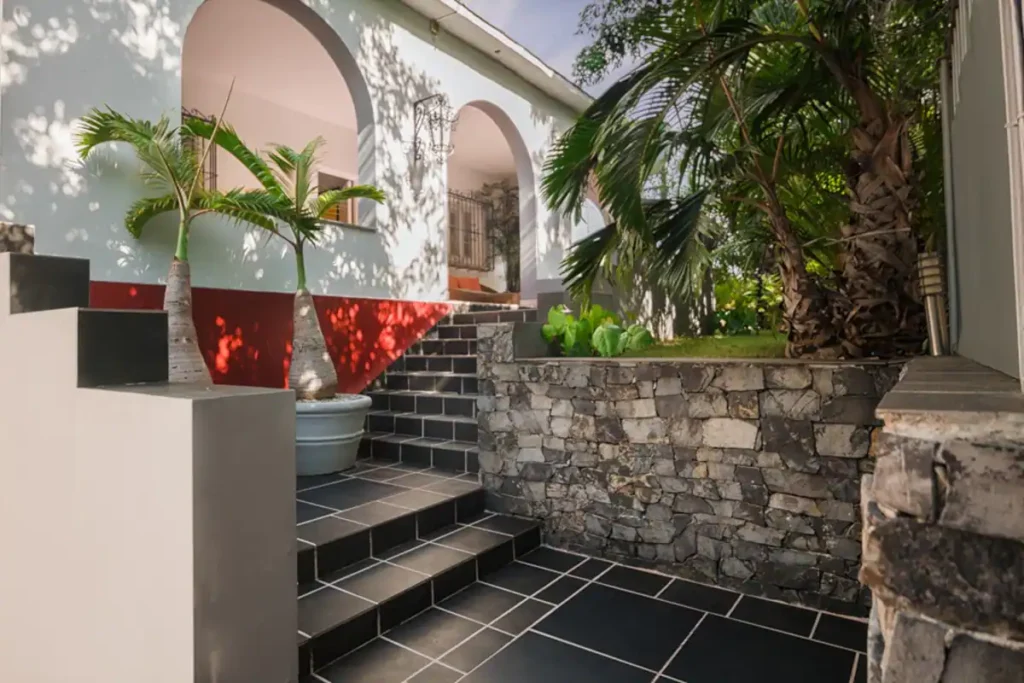 Black tiled staircase and art at Villa Las Cañas