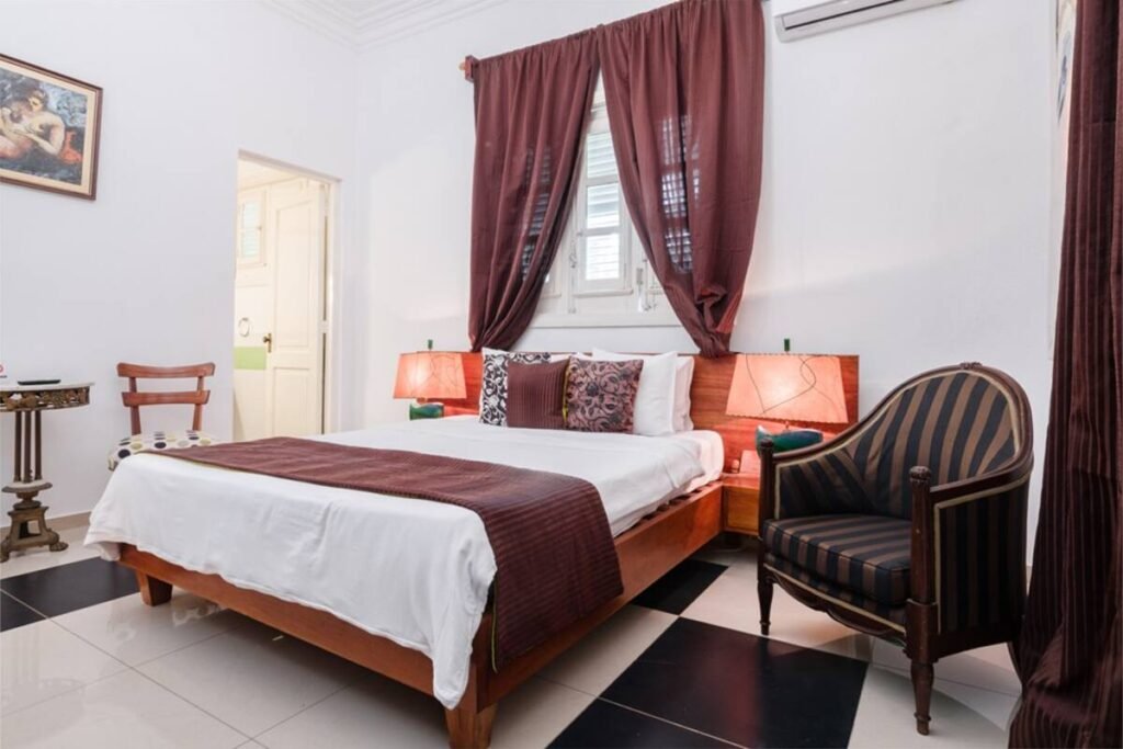 King bedroom with vintage chair at Villa Las Cañas