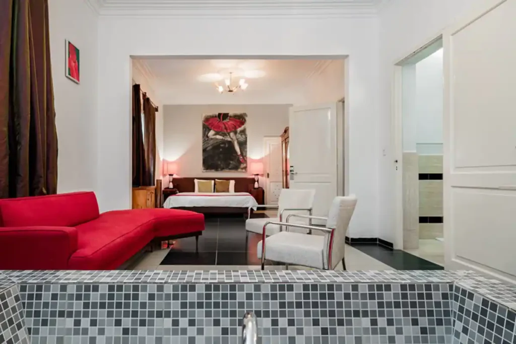 Red bedroom suite and sitting area at Villa Las Cañas