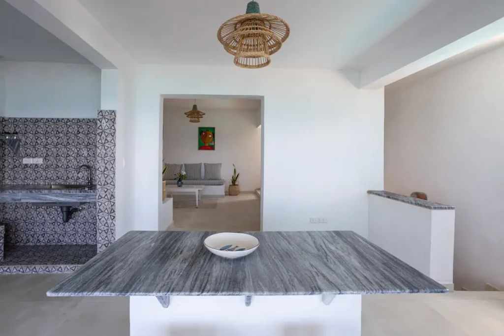 Open-plan kitchen and dining island at Villa Luca