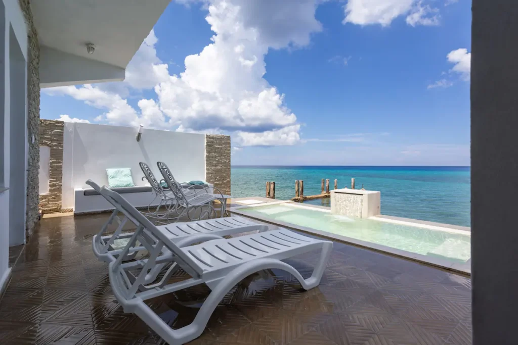 Sun loungers beside the waterfront jacuzzi pool at Villa Luca