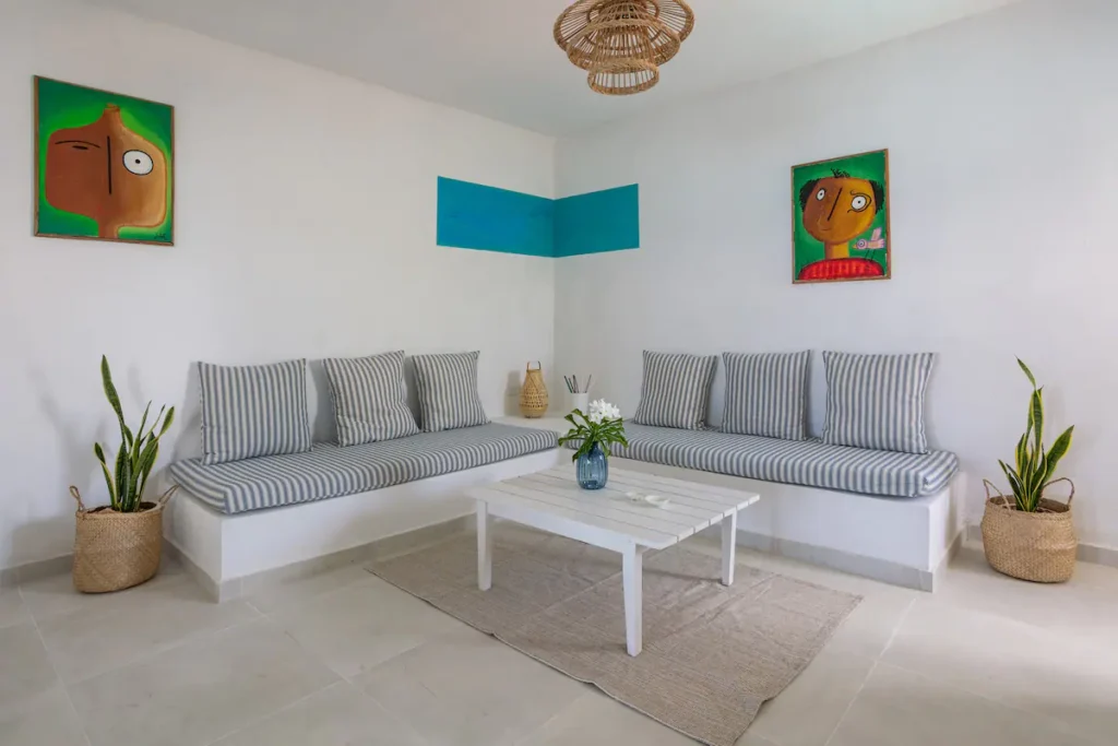 Bright lounge with striped seating at Villa Luca