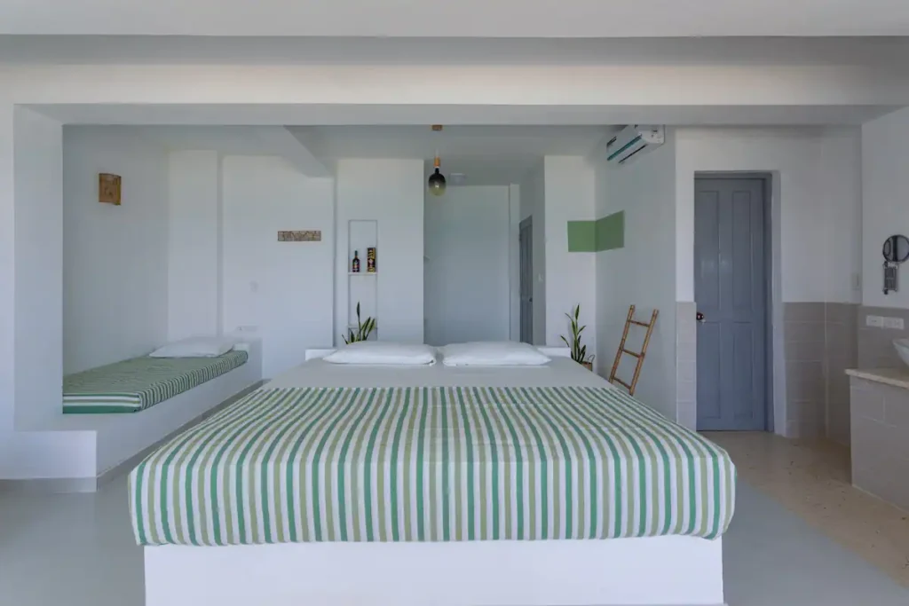 King bedroom with pale green accents at Villa Luca