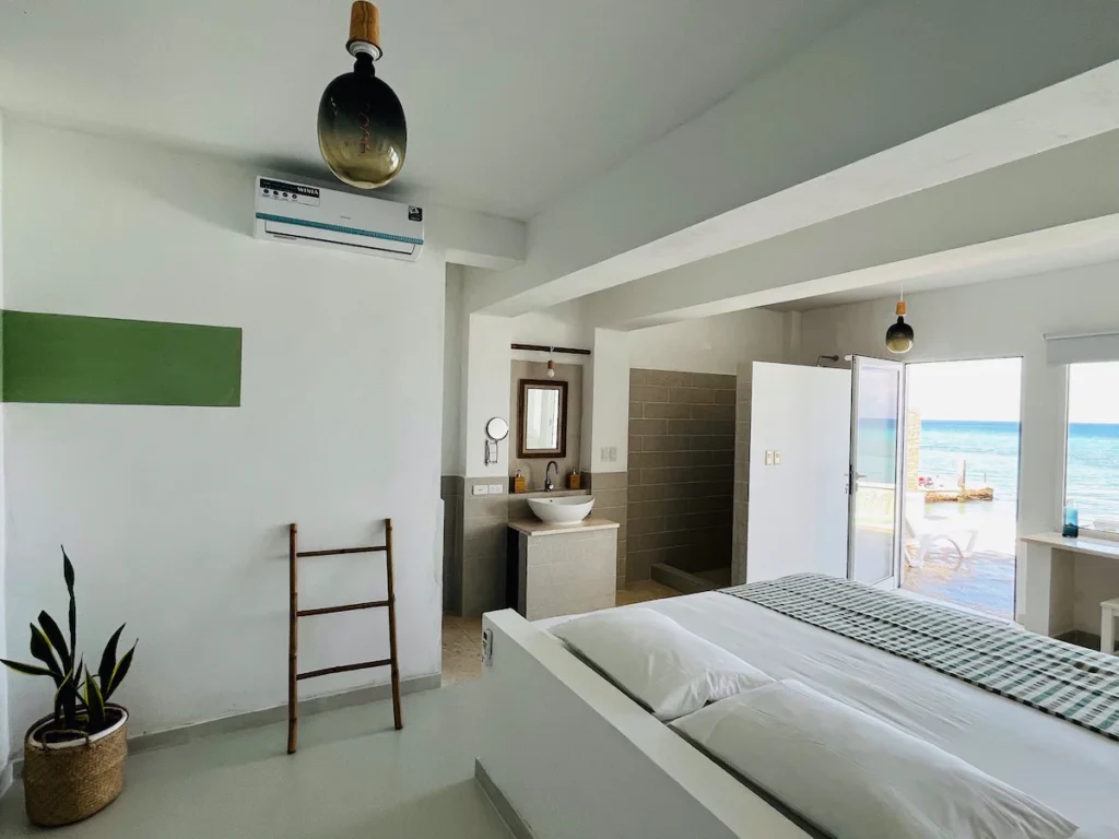 King bedroom and open bathroom area at Villa Luca