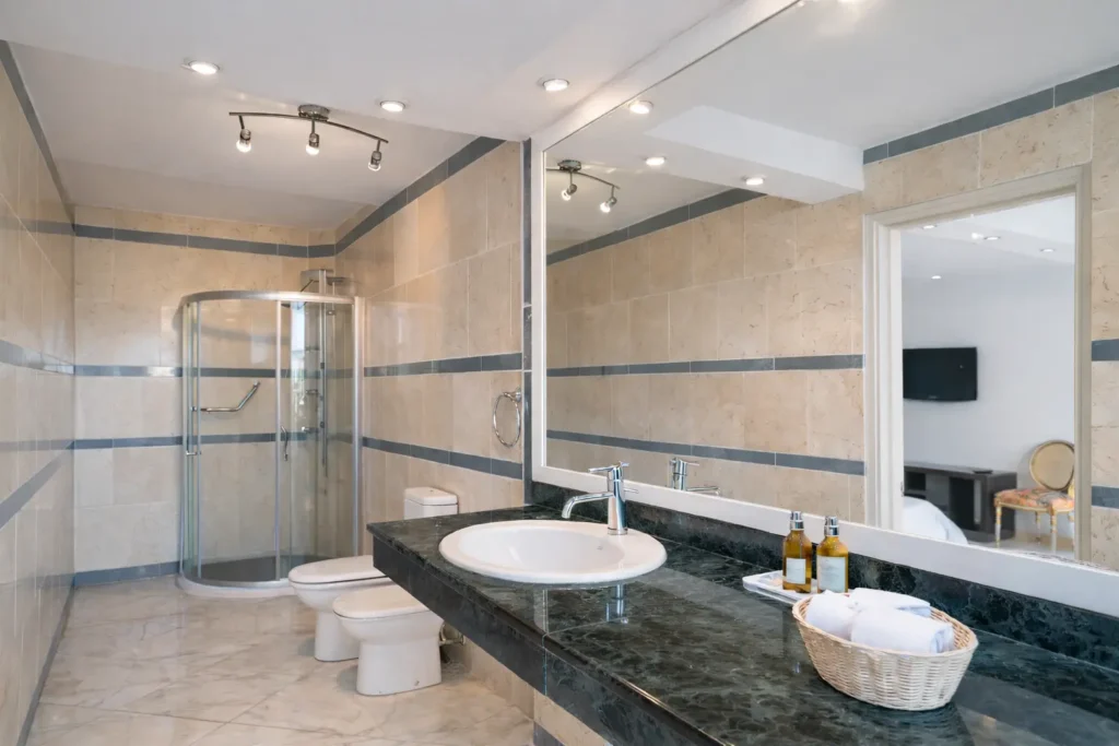 Baño de mármol con ducha a ras de suelo en Luxury Rio Mar