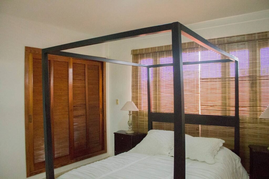 Queen bedroom with canopy frame at Villa Maison